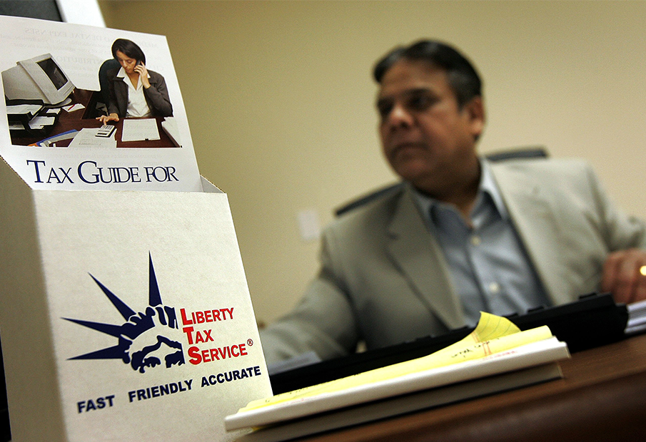 Man behind a Liberty Tax Service pamphlet holder