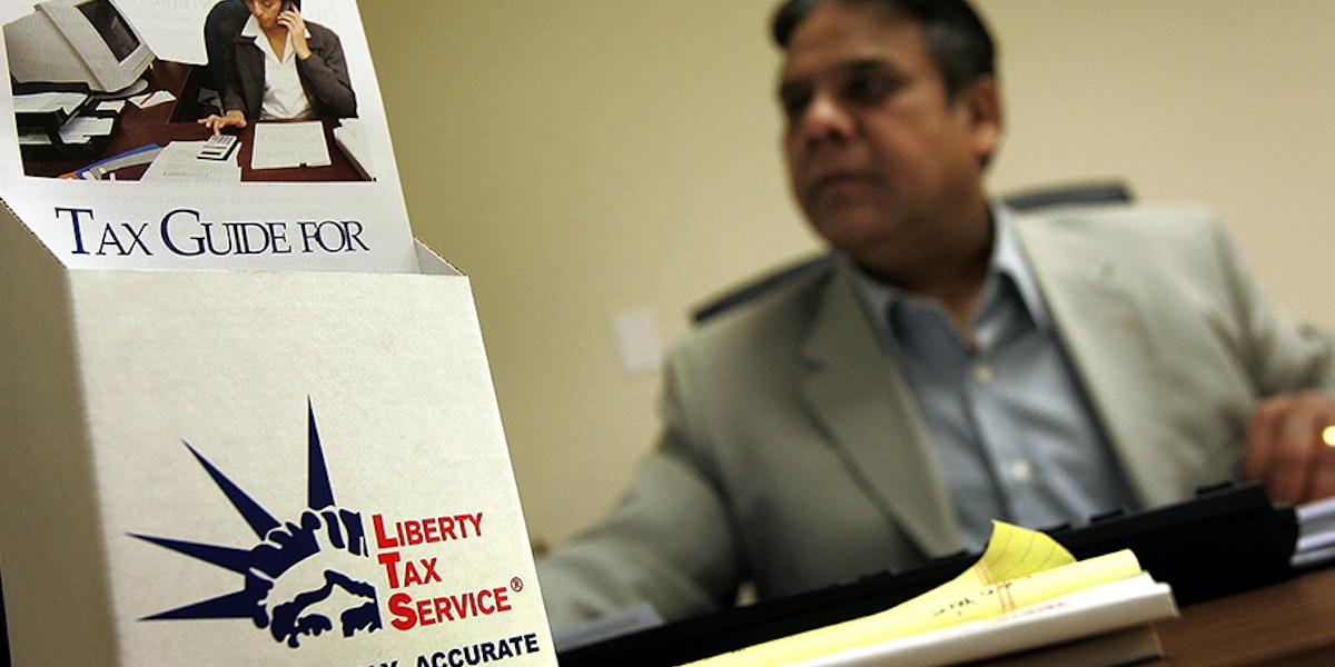 Man behind a Liberty Tax Service pamphlet holder