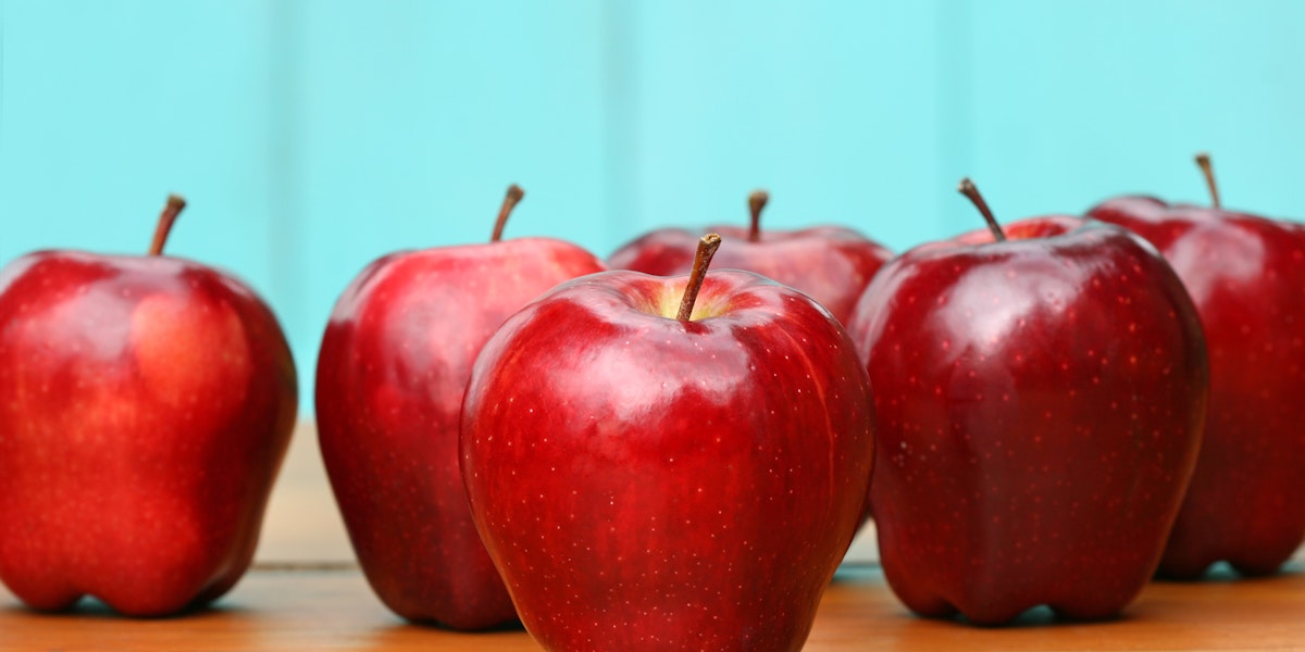 Red delicious apples on old school desk