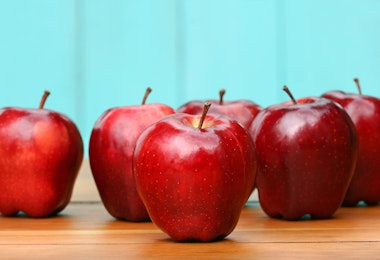 Red delicious apples on old school desk