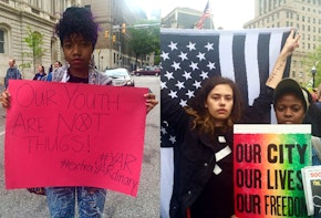Baltimore youth holding signs and a flag
