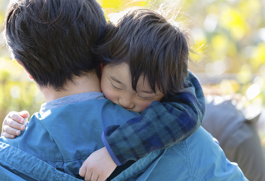 a man carrying a child on his sholder