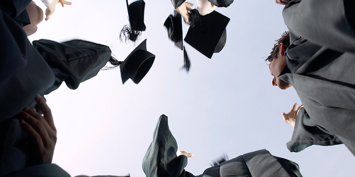 Graduation caps in tossed in the air