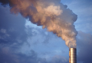 a smokestack emits from the top of a building