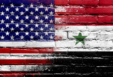 USA and Syria Flag painted on brick wall