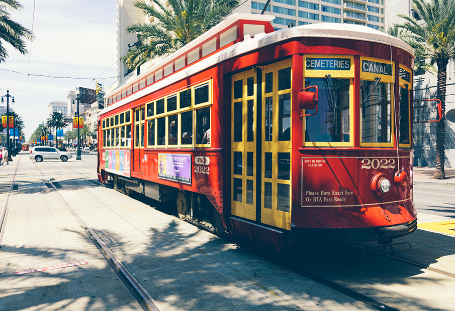 a red trolley car on a city street