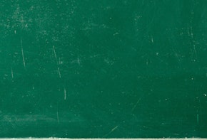 a green chalkboard with a toothbrush and toothpaste on it
