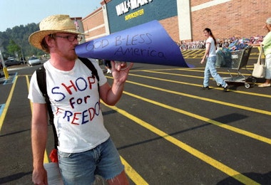 ATHENS, OH - AUGUST 14:  Ohio University graduate student Jeremy Ernst protests the grand opening of a Wal-Mart Supercenter August 14, 2002 in Athens, Ohio. Ernst accuses the store of stocking their shelves with products made in sweatshops. The 209,000-square-foot store will employ about 450 workers and is one of 17 Supercenters scheduled to open today around the U.S. along with four Wal-Mart Stores. Local residents are concerned that the opening of the store will threaten local businesses.  (Photo by Shaun Heasley/Getty Images)