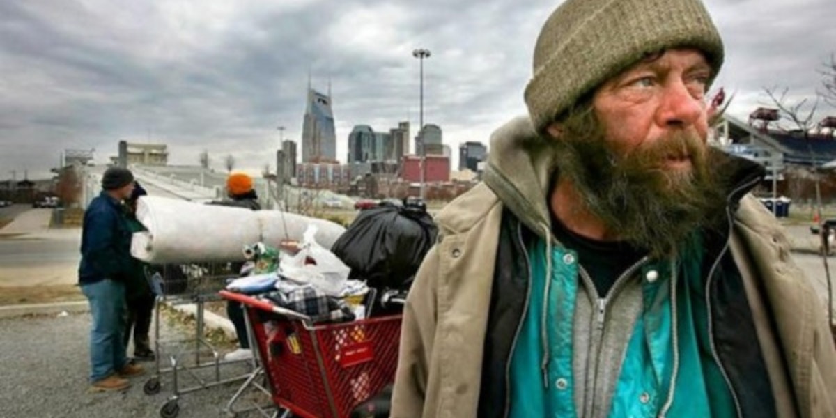 -

- Homeless man John Wayne and others wait in a parking lot near LP Field after Metro police had them move their possessions from under the Shelby Street Bridge. Wayne said police have been nice about giving them time to move. A recent count by a national organization found 1,542 homeless people living in Nashville in January 2005. -

-.JOHN PARTIPILO/THE TENNESSEAN
