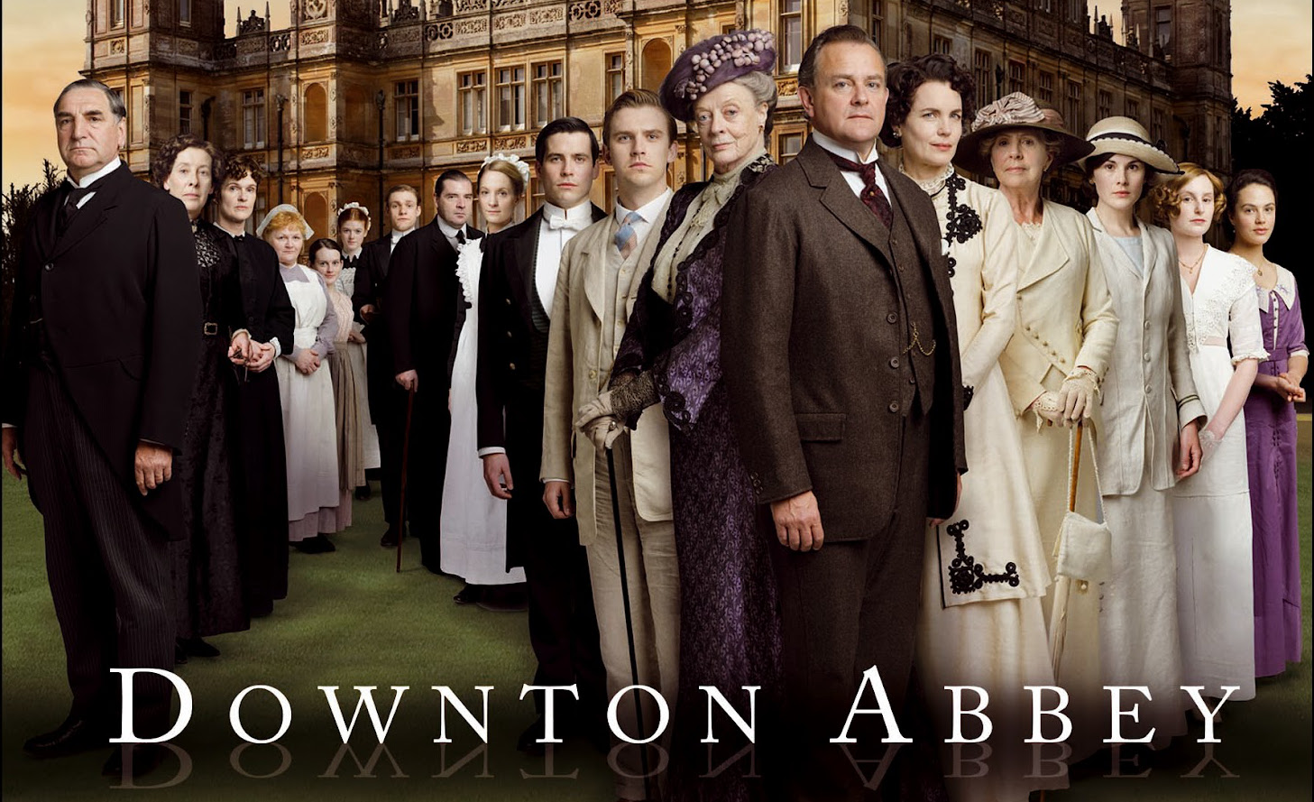A Poster of Downtown Abbey of people dressed formerly in an array in front of a castle.