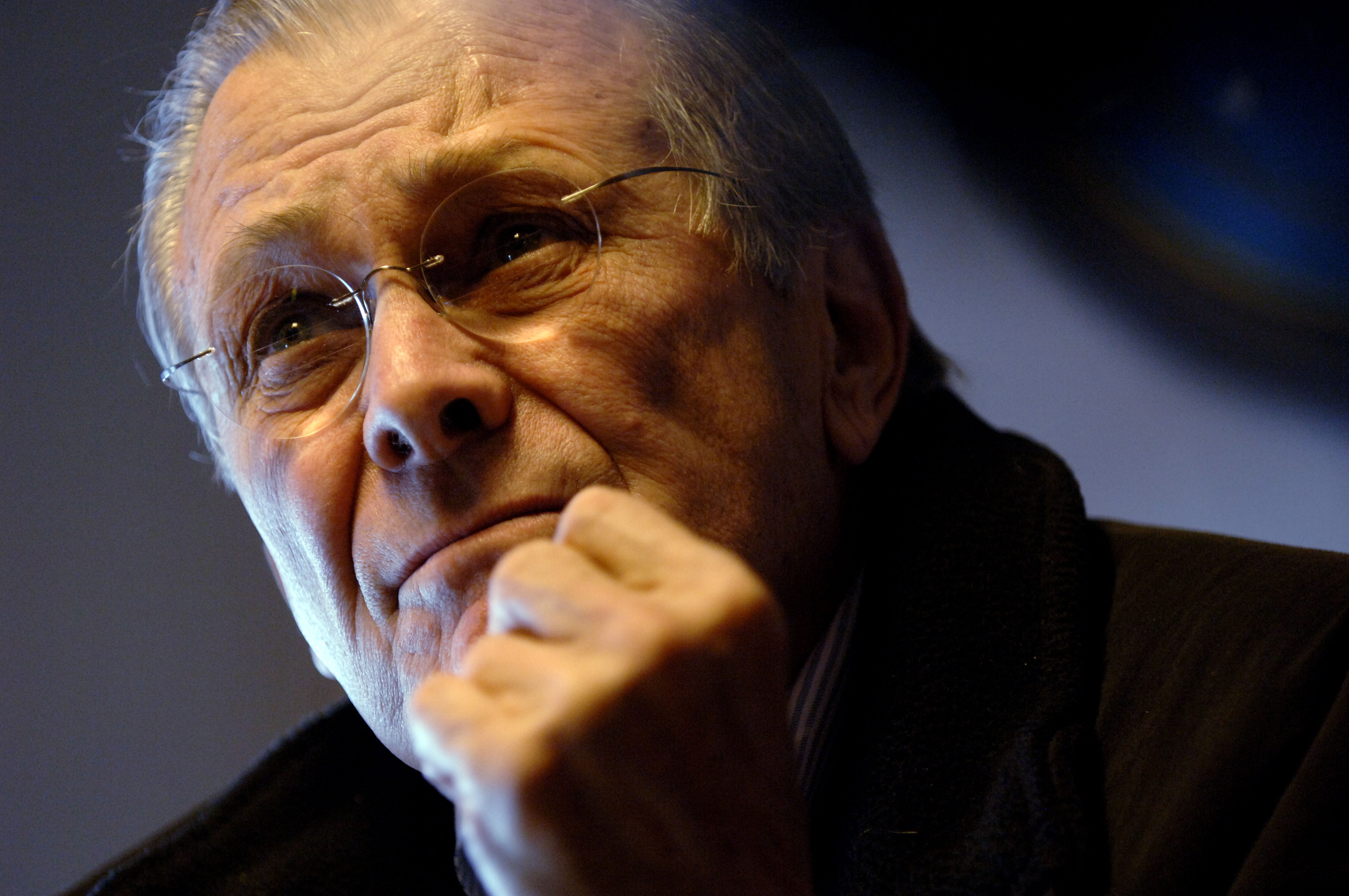 051220-N-0696M-054	Secretary of Defense Donald H. Rumsfeld listens to a question from the media during an in-flight press briefing on a U.S. Air Force C-32A aircraft en route to Shannon, Ireland, on Dec. 20, 2005.  DoD photo by Petty Officer 1st Class Chad J. McNeeley, U.S. Navy.  (Released)