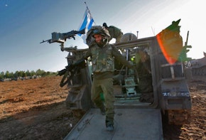 GAZA BORDER, ISRAEL - JANUARY 13:  An Israeli soldier dismounts from an APC after returning from fighting against Hamas militants in the Gaza Strip on January 13, 2009 at a forward deployment area on Israel's border with the Palestinian territory. Israel is intensifying its wide-scale ground assault against the Gaza Strip in an effort to put an end to Hamas rocket attacks against the Jewish State.  (Photo by David Silverman/Getty Images)