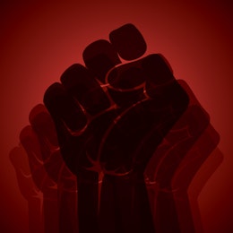 a red background with a black silhouette of a fist