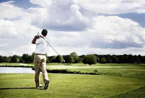A man playing golf
