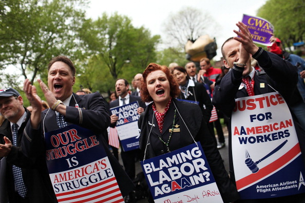 NEW YORK, NY - APRIL 23:  American Airlines and American Eagle employees prepare to march to U.S. Bankruptcy Court to protest against American's plans to cut jobs and labor costs while under bankruptcy court protection on April 23, 2012 in New York City. American is seeking permission to break-up union contracts and cut expenses by $1.25 billion. The airline's three major unions, while opposing the company's restructuring plans, announced Friday that they would support a potential takeover bid by US Airways.  (Photo by Spencer Platt/Getty Images)