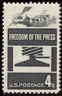 Freedom of the press stamp. An image of a persn holding a feather pen.