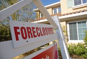 Foreclosure sign in front of a property