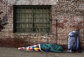 A person sleeping on a sidewalk