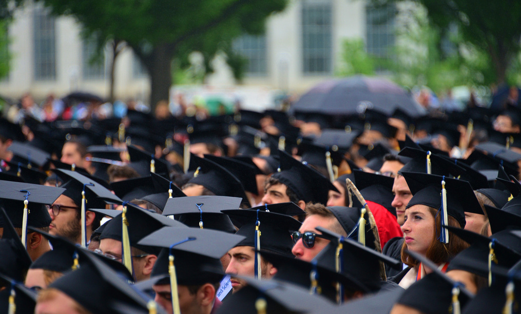 a large group of people in graduation caps and gowns