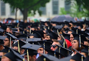 a large group of people in graduation caps and gowns