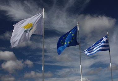 a group of three flags flying in the air