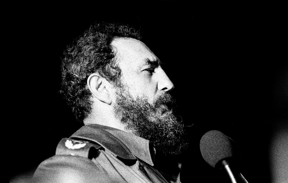 Fidel Castro speaking in front of a podium