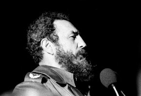 Fidel Castro speaking in front of a podium