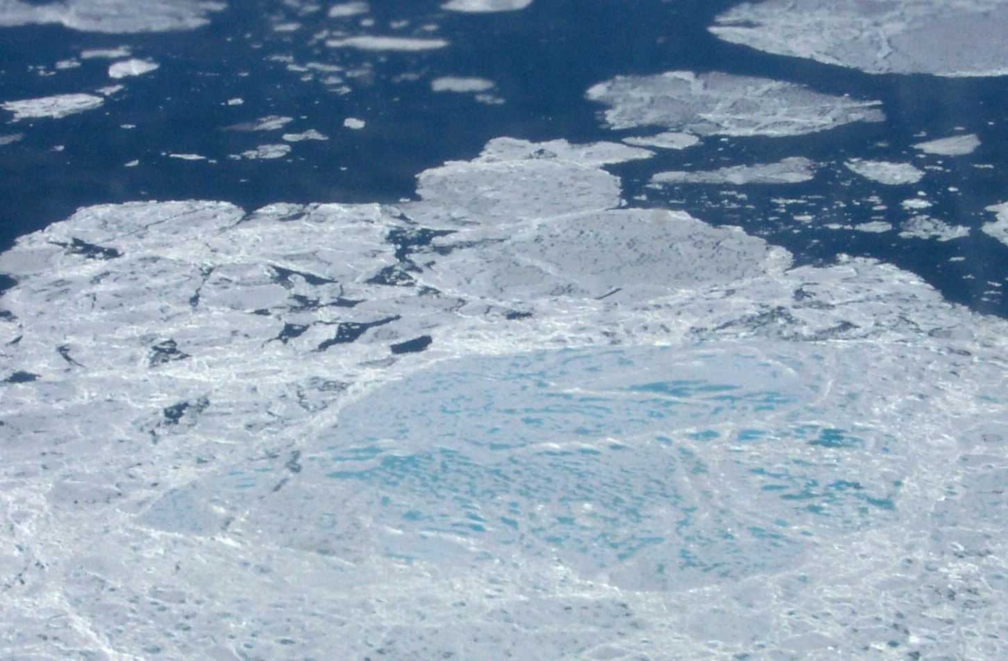 an aerial view of ice floes and water