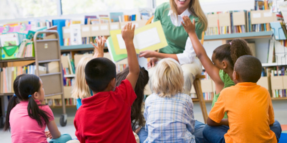 Kindergarten teacher reading to children