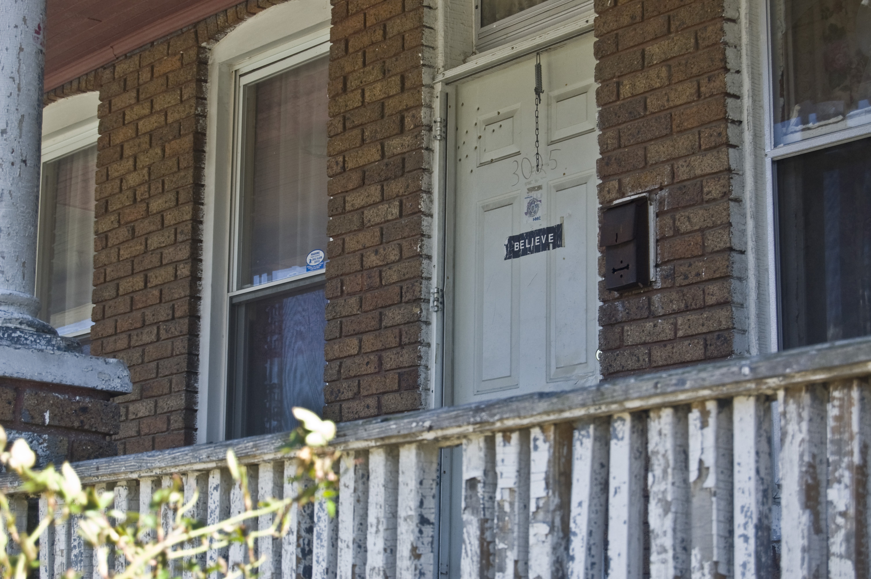 a brick building with a white door and window