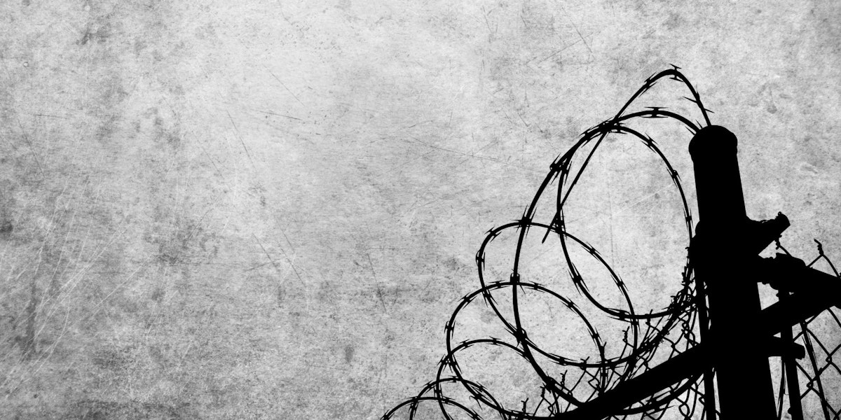 Grunge background with barbed wire fence