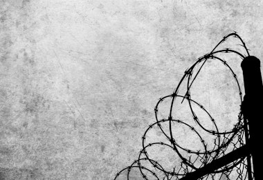 Grunge background with barbed wire fence