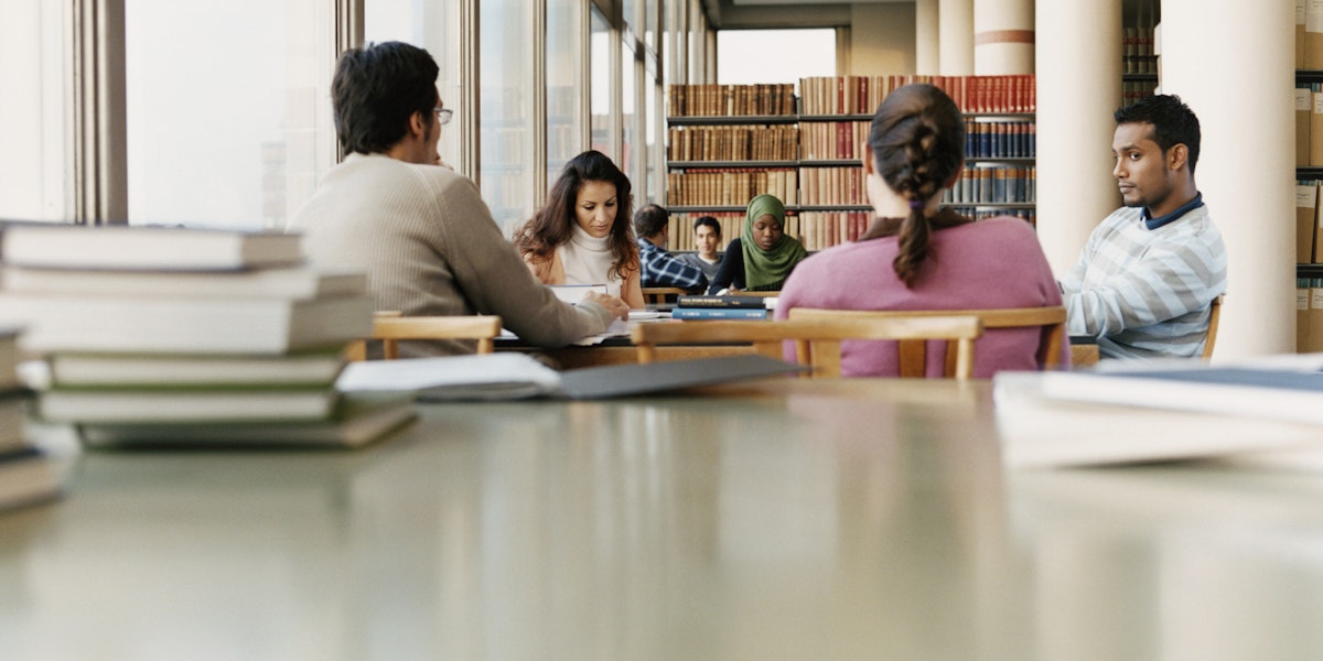 Surface Level Shot of Mature Students Sitting at a Table in a University Library