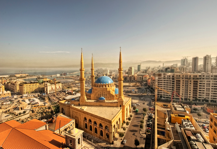 a large building with a blue dome in the middle of a city