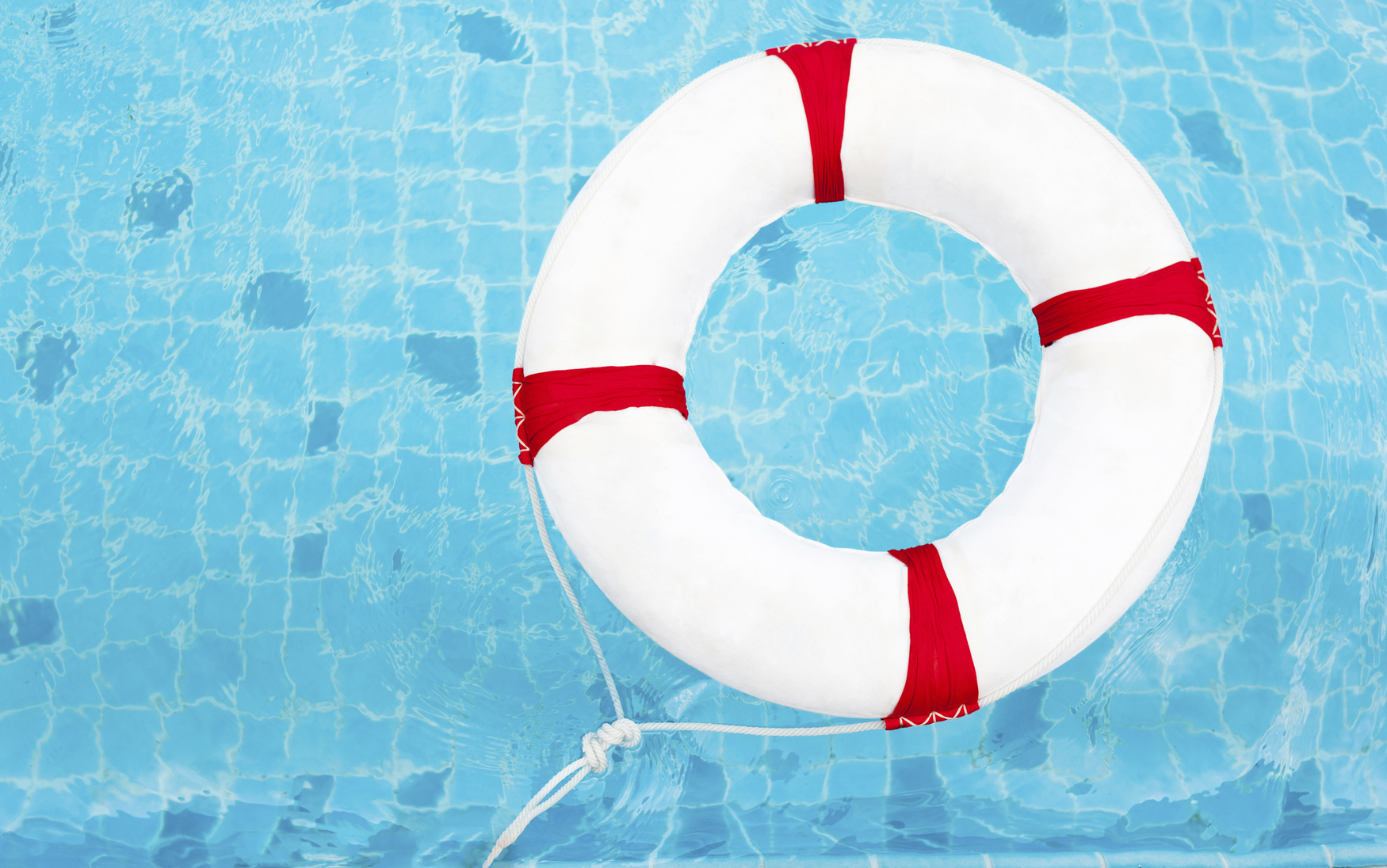 Life Ring at the swimming pool. Life Ring on water. Life Ring on blue water.