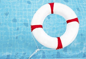 Life Ring at the swimming pool. Life Ring on water. Life Ring on blue water.