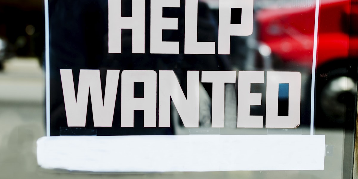 Help wanted sign outside of a store in the United States.