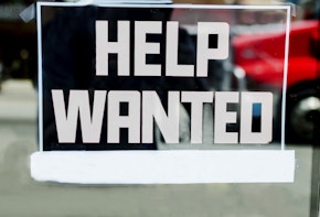Help wanted sign outside of a store in the United States.