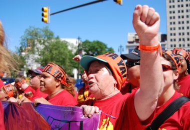 a group of people wearing red shirts and orange hats
