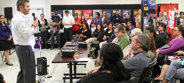 Chief of the Office of Transformation and Innovation, Mike Koprowski, addresses a room full of prospective parents at an Open House.