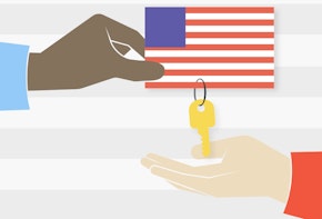 a person holding a picture of america with a key attatched to it