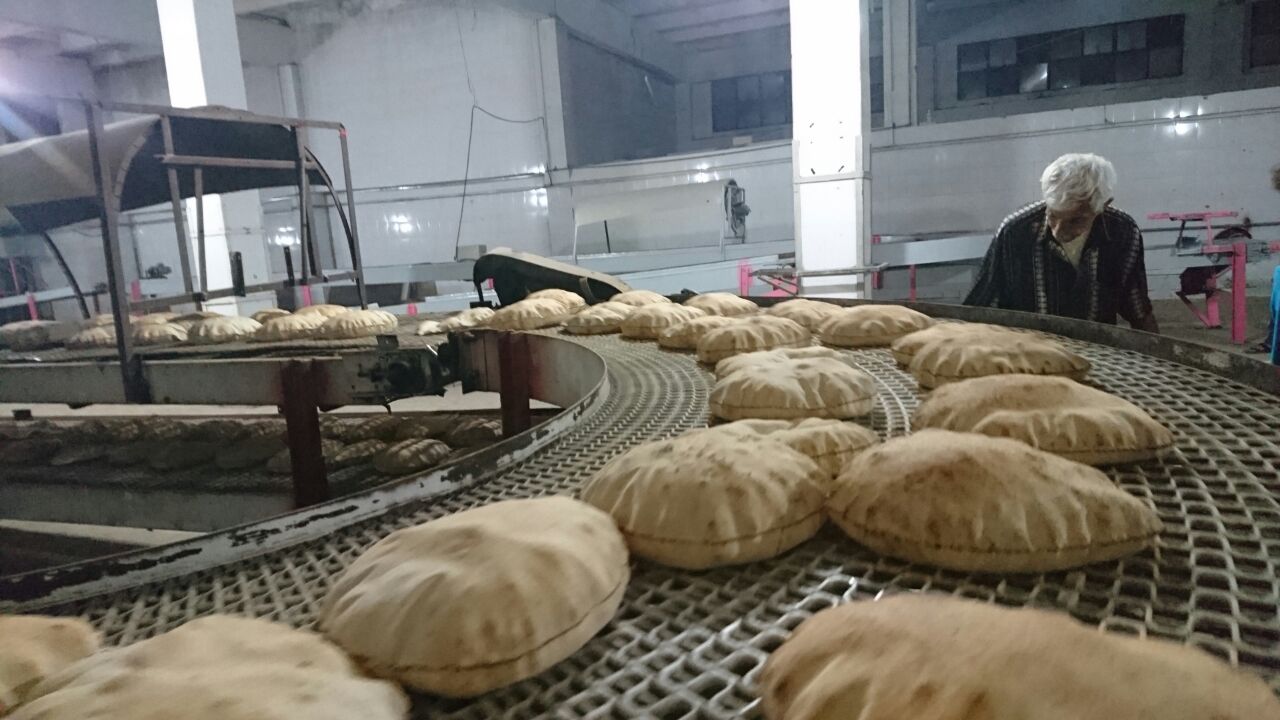 a conveyor belt filled with lots of bread