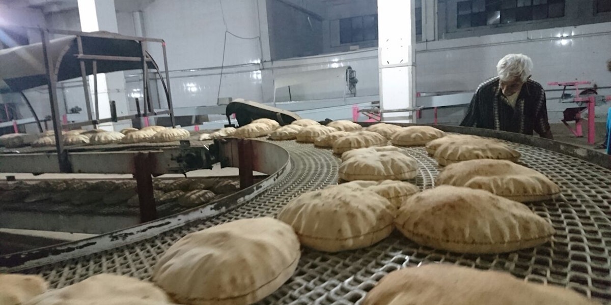 a conveyor belt filled with lots of bread
