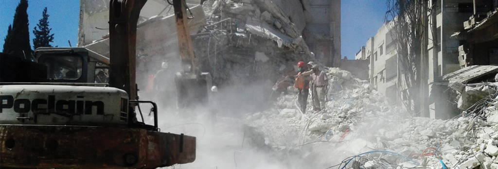 Civil Defense team works to pull bodies from scene of airstrike.