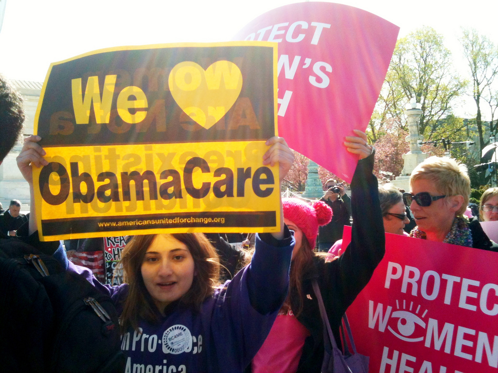 a group of people holding signs in the air
