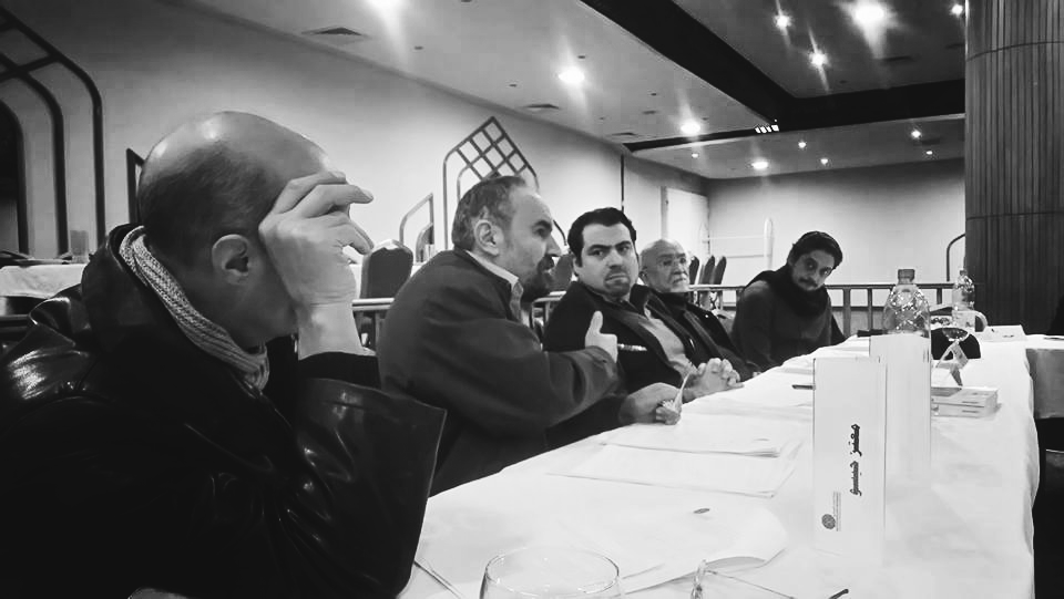 a group of people sitting at a table in a restaurant