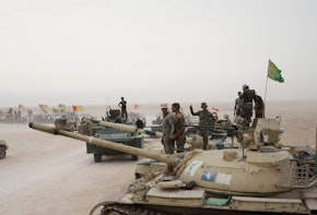 A photograph of military tanks and soldiers in the middle east