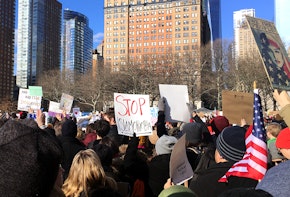 Photograph of a rally with the signs saying stop Islamphobia