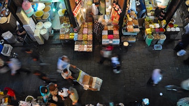 an overhead view of people shopping in a market