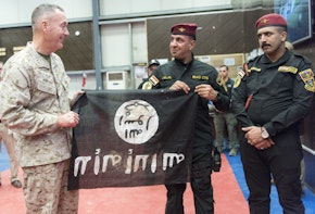 Members from the Iraqi Counter Terrorism Service present Marine Gen. Joseph F. Dunford, chairman of the Joint Chiefs of Staff, with a flag from Bartilah, a town recaptured just outside of Mosul from the Islamic State of Iraq and the Levant. This flag symbolizes the efforts of Combined Joint Task Force - Operation Inherent Resolve composed of U.S. Army Soldiers, U.S. Marine Corps Marines, U.S. Navy Sailors, United States Air Force Airmen and coalition military forces. (DoD Photo by Navy Petty Officer 2nd Class  Dominique A. Pineiro/released)